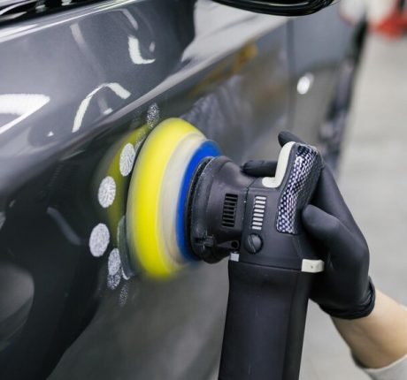 car-detailing-worker-with-orbital-polisher-auto-repair-shop-selective-focus_473712-3725