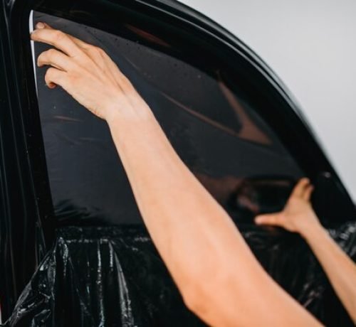 specialist-work-with-car-tinting-film-installing_266732-11732