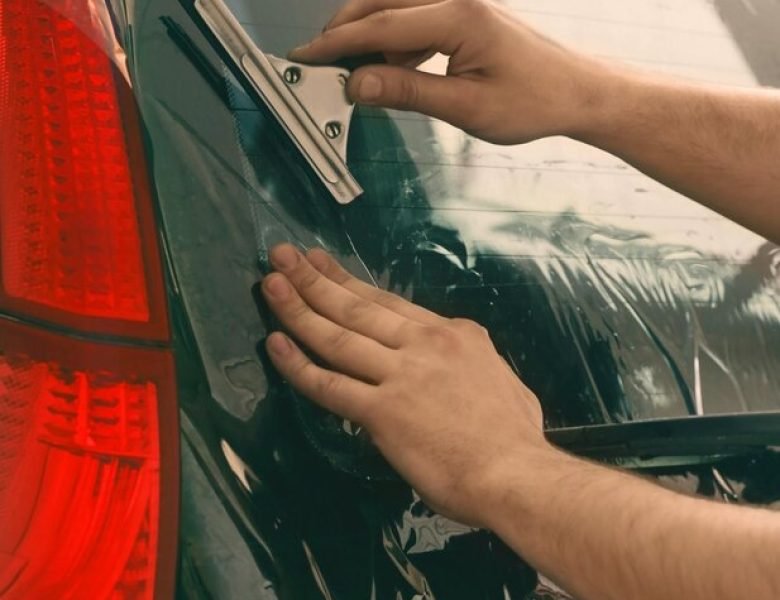worker-applying-tinting-foil-onto-car-window_392895-102725